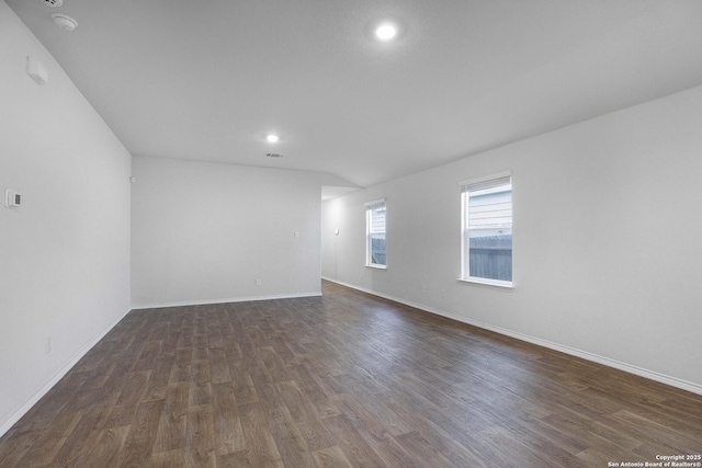 spare room featuring dark wood-type flooring