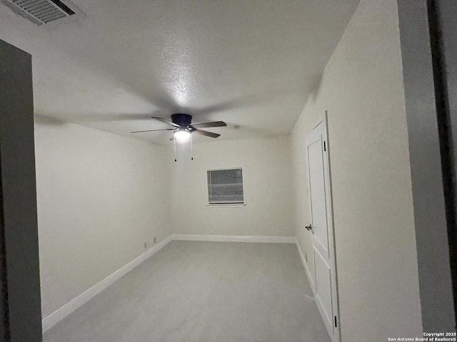 empty room with a textured ceiling and ceiling fan