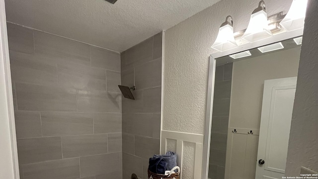 7438 Rimhurst, San Antonio, TX 78250 - full bathroom with a textured wall, a textured ceiling, and tiled shower