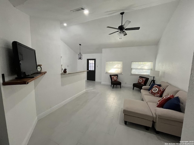 living room featuring ceiling fan and lofted ceiling