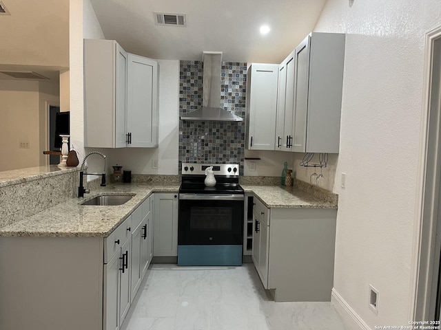 kitchen featuring gray cabinetry, light stone countertops, sink, wall chimney range hood, and stainless steel electric range