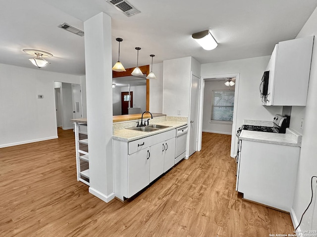 kitchen with pendant lighting, white cabinets, white dishwasher, sink, and light hardwood / wood-style flooring