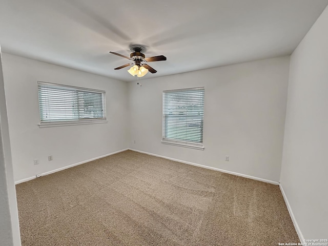 carpeted empty room featuring ceiling fan and plenty of natural light