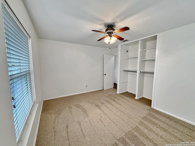 unfurnished bedroom featuring carpet flooring, ceiling fan, and a closet