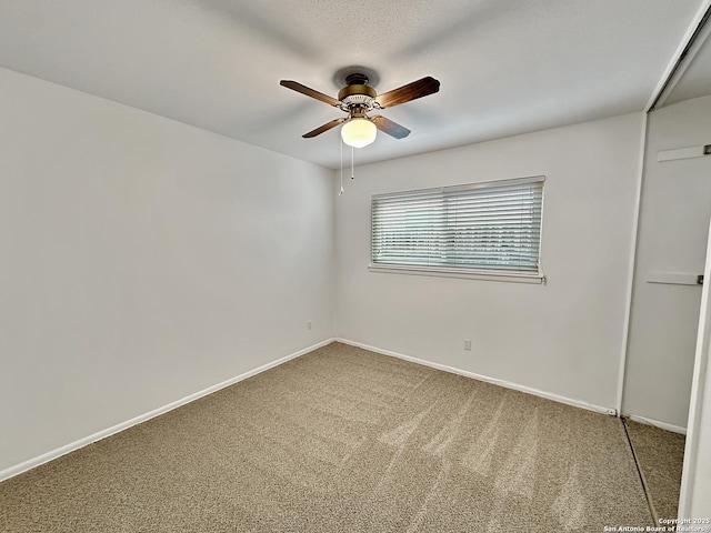 empty room with carpet flooring and ceiling fan