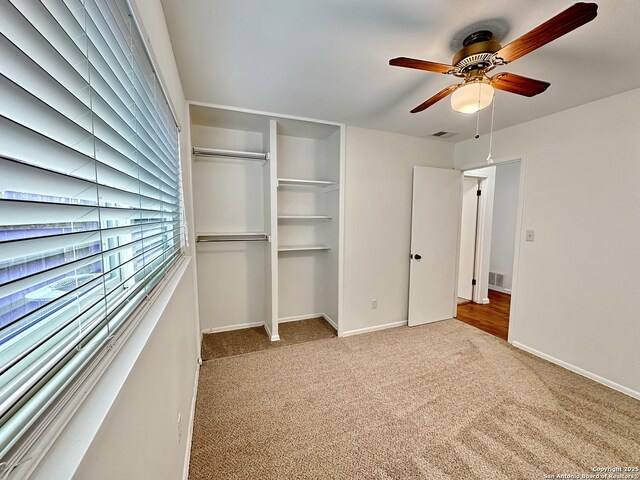 unfurnished bedroom with ceiling fan, a closet, and light carpet