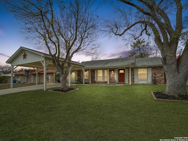 ranch-style house with a yard and a carport