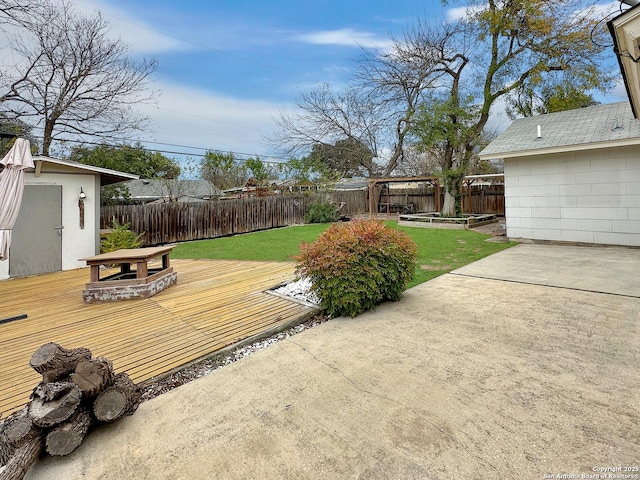 deck with a lawn, an outbuilding, and a patio