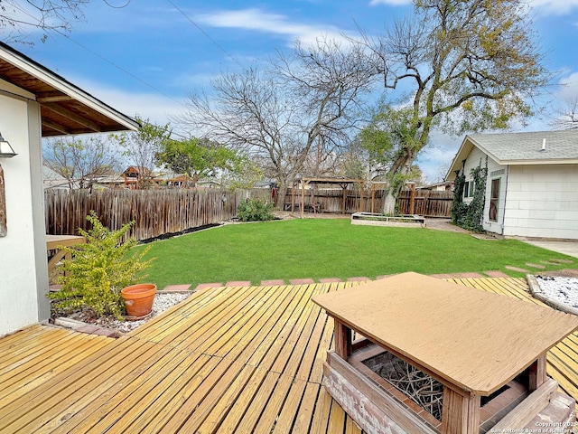 wooden deck featuring a yard