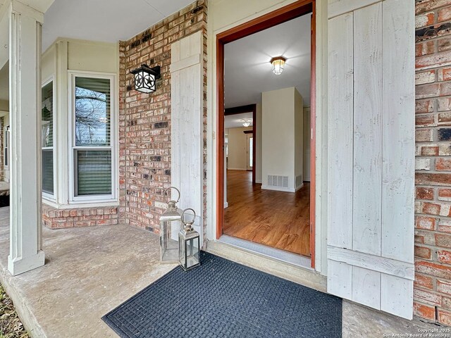 view of exterior entry with covered porch