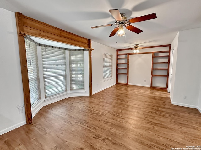 unfurnished room featuring light wood-type flooring and ceiling fan