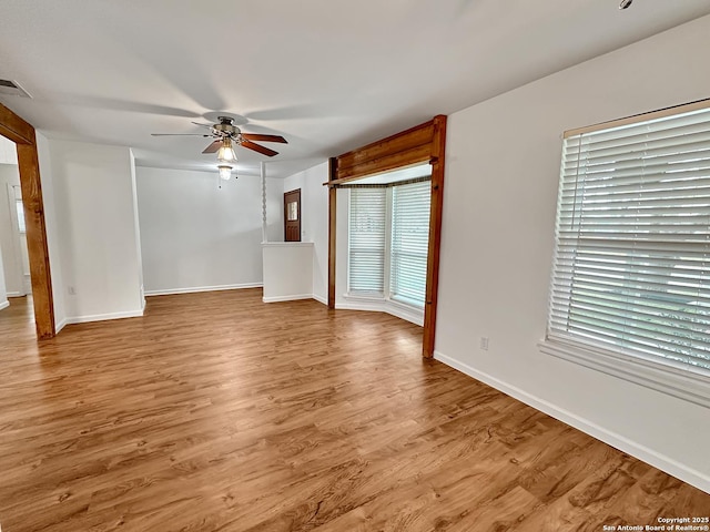 unfurnished room featuring ceiling fan, light hardwood / wood-style flooring, and plenty of natural light