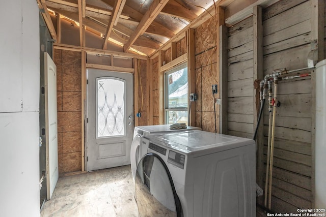 washroom with separate washer and dryer and light hardwood / wood-style floors