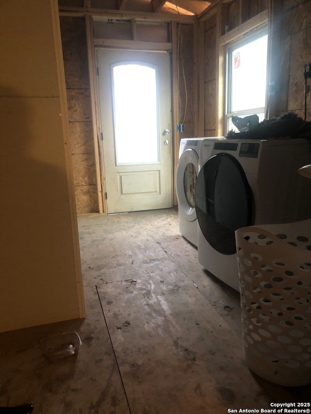 clothes washing area featuring independent washer and dryer