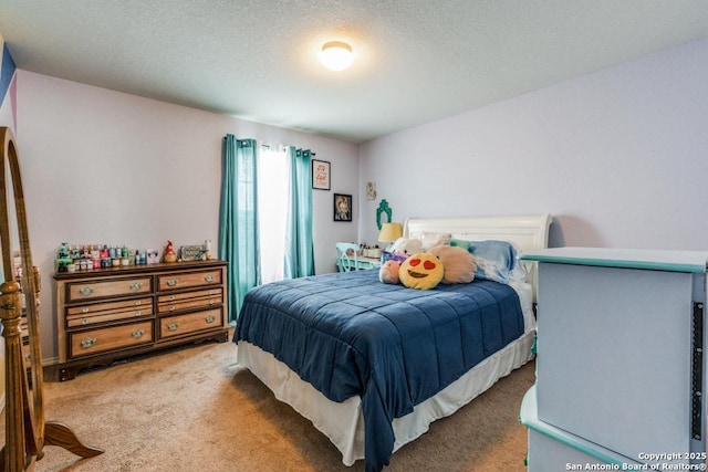 bedroom with carpet floors and a textured ceiling