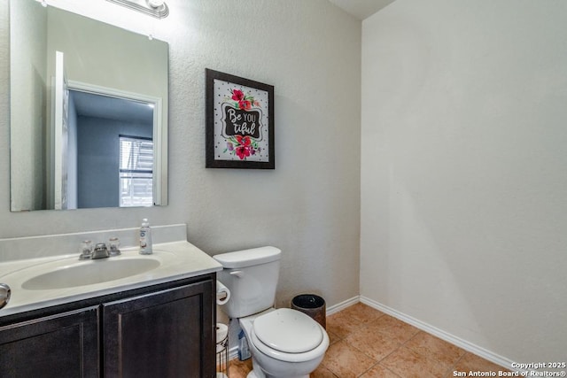 bathroom with tile patterned floors, vanity, and toilet