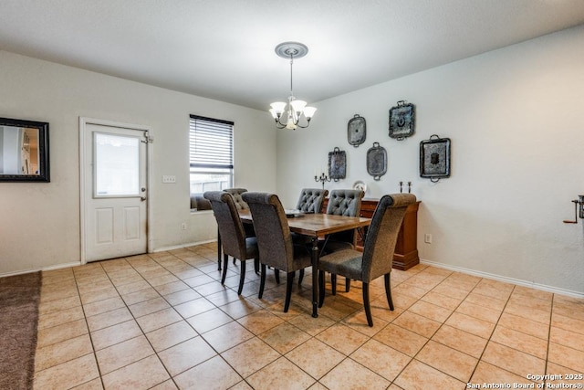 dining space with light tile patterned flooring and an inviting chandelier