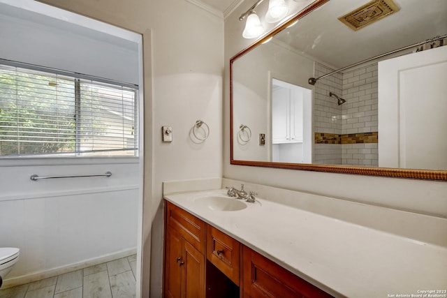 bathroom featuring vanity, toilet, and crown molding