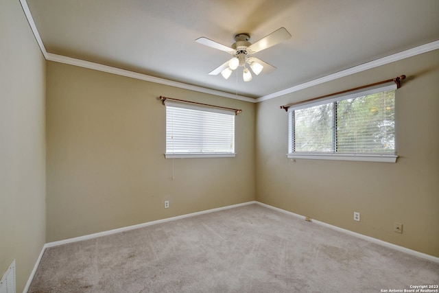 carpeted empty room featuring ceiling fan and crown molding