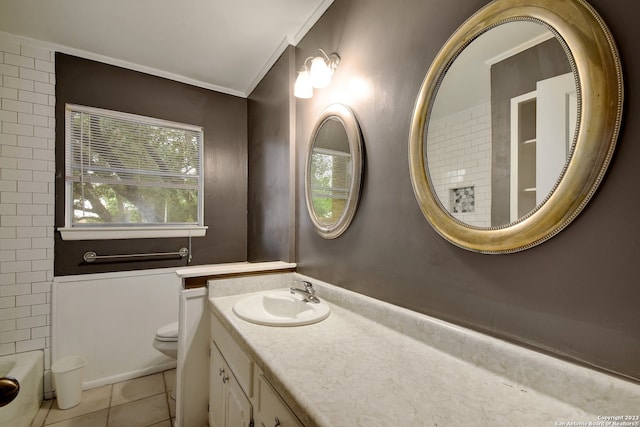 bathroom featuring tile patterned floors, a bathtub, ornamental molding, vanity, and toilet