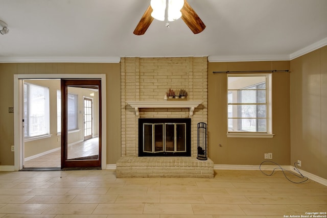 unfurnished living room with a fireplace, ceiling fan, and ornamental molding