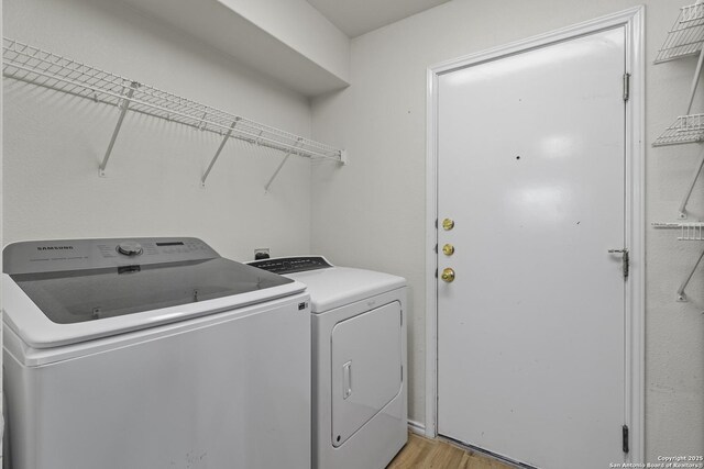 washroom featuring light hardwood / wood-style flooring and independent washer and dryer