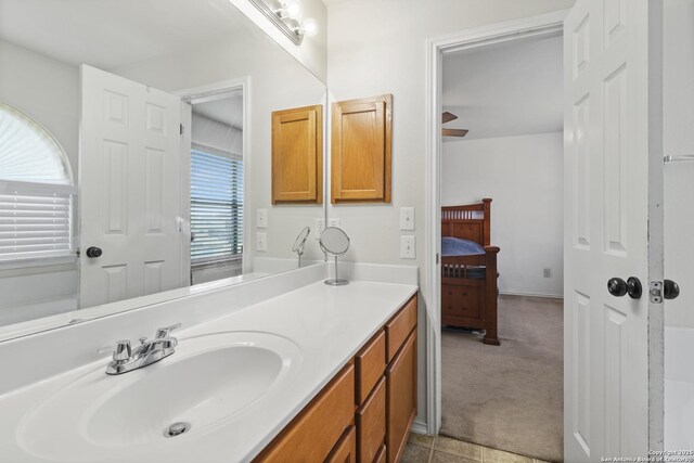 bathroom with ceiling fan, tile patterned flooring, and vanity