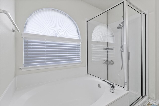 bathroom featuring separate shower and tub