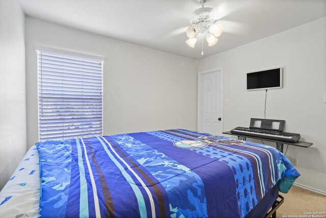 carpeted bedroom featuring ceiling fan