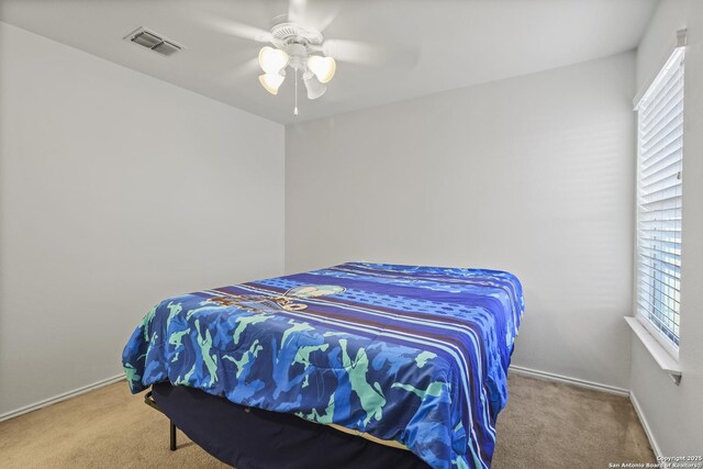 carpeted bedroom with ceiling fan