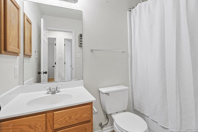 full bathroom featuring vanity, shower / bath combination with curtain, and toilet