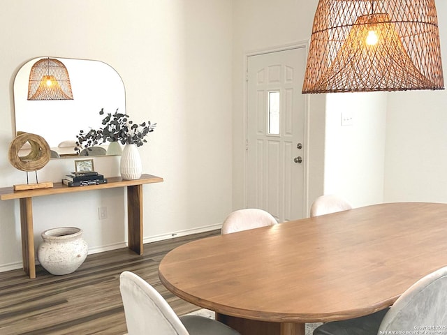 dining space with dark hardwood / wood-style floors