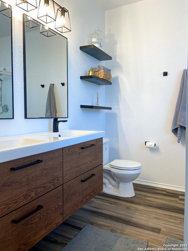 bathroom with vanity, hardwood / wood-style flooring, and toilet