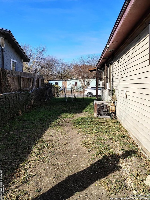 view of yard featuring central air condition unit