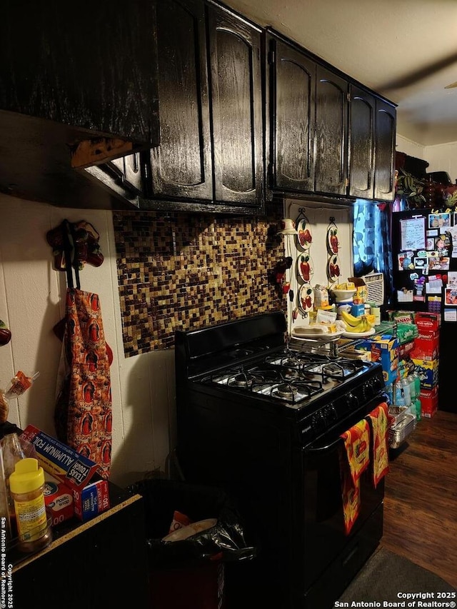 kitchen featuring black gas stove and backsplash