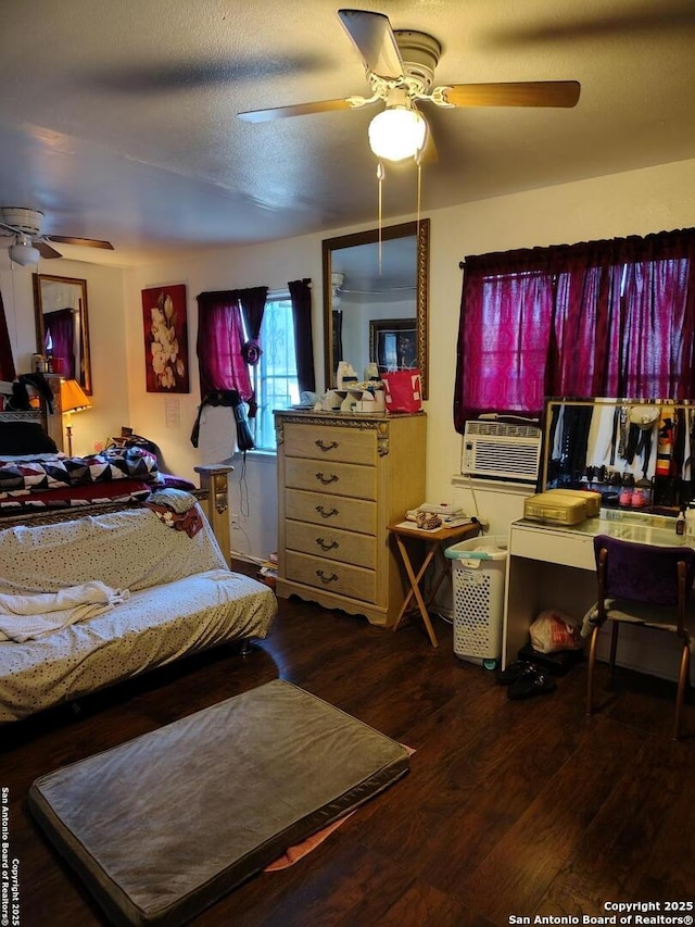 bedroom with a textured ceiling, hardwood / wood-style flooring, ceiling fan, and cooling unit