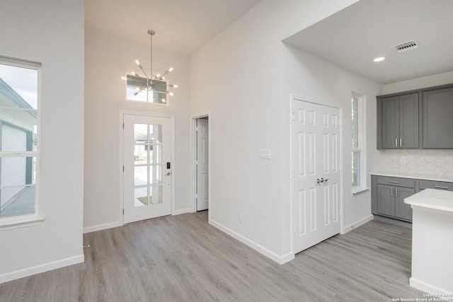 foyer featuring a chandelier and light hardwood / wood-style floors