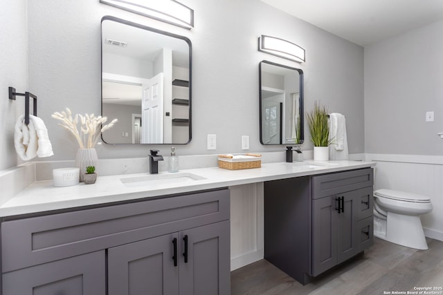 bathroom featuring hardwood / wood-style floors, vanity, and toilet