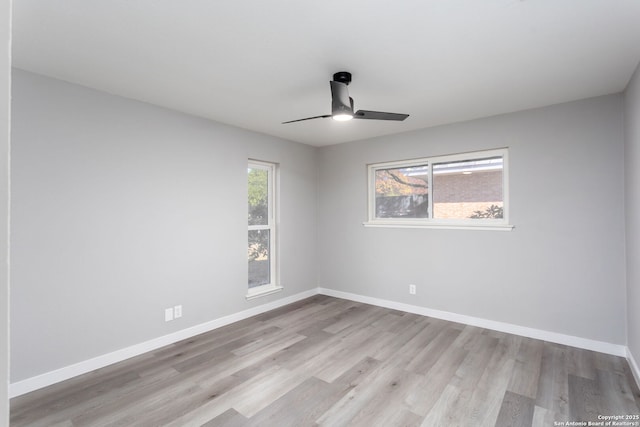 spare room featuring ceiling fan and light hardwood / wood-style flooring