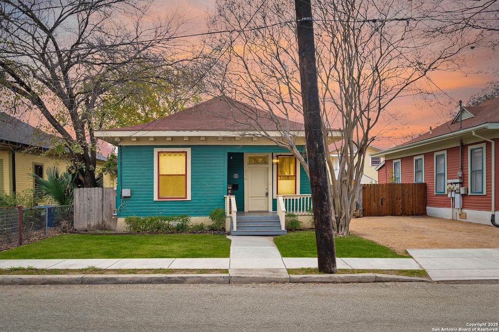 bungalow-style home featuring a yard