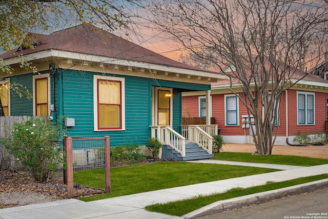 view of front of house with a front yard and covered porch