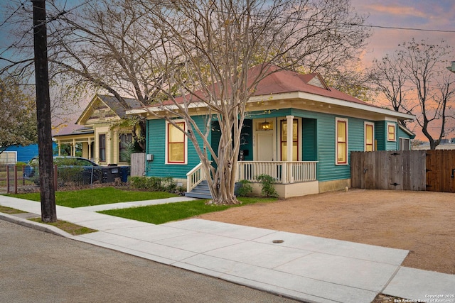 bungalow-style house featuring a yard and covered porch