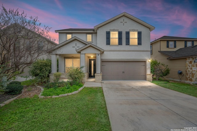 view of front of home with a garage and a yard