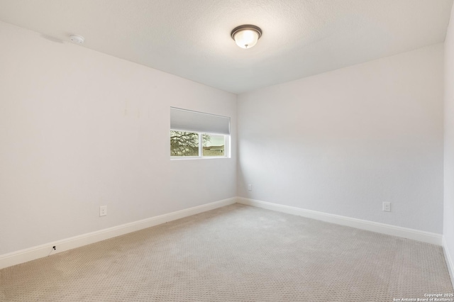 carpeted empty room with a textured ceiling