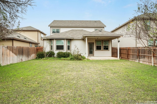 rear view of house featuring a yard and a patio