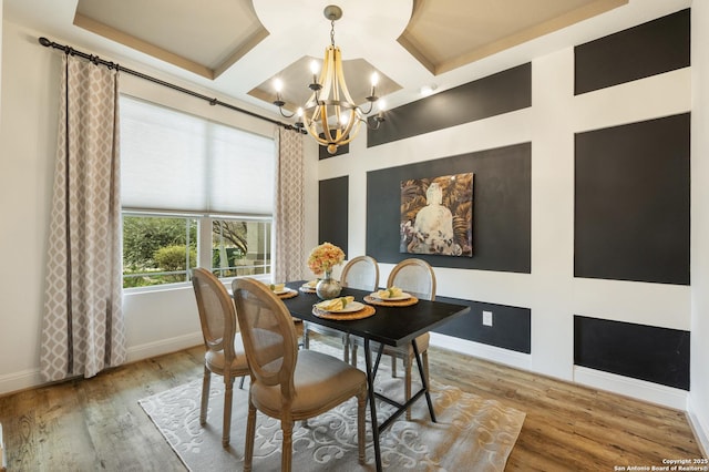 dining area featuring a chandelier, hardwood / wood-style flooring, and coffered ceiling