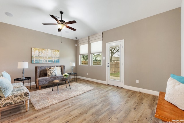 living area featuring ceiling fan and light hardwood / wood-style floors