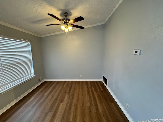 empty room with ceiling fan, dark hardwood / wood-style flooring, a textured ceiling, and crown molding