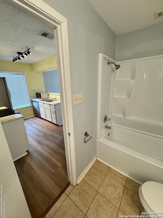 full bathroom with shower / tub combination, tile patterned flooring, vanity, and toilet