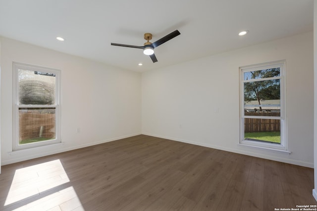 empty room featuring dark wood-type flooring and ceiling fan